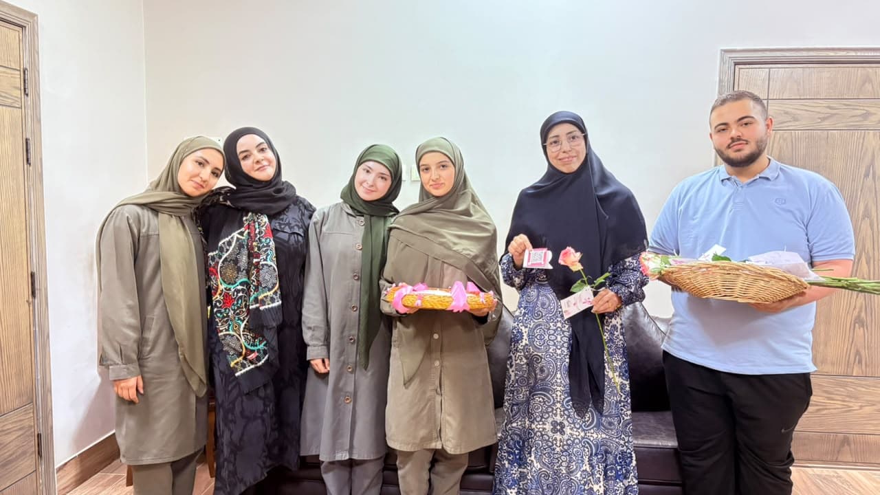 Head director Souad Marrah (second from right) with students of the initiative, holding awareness cards and roses